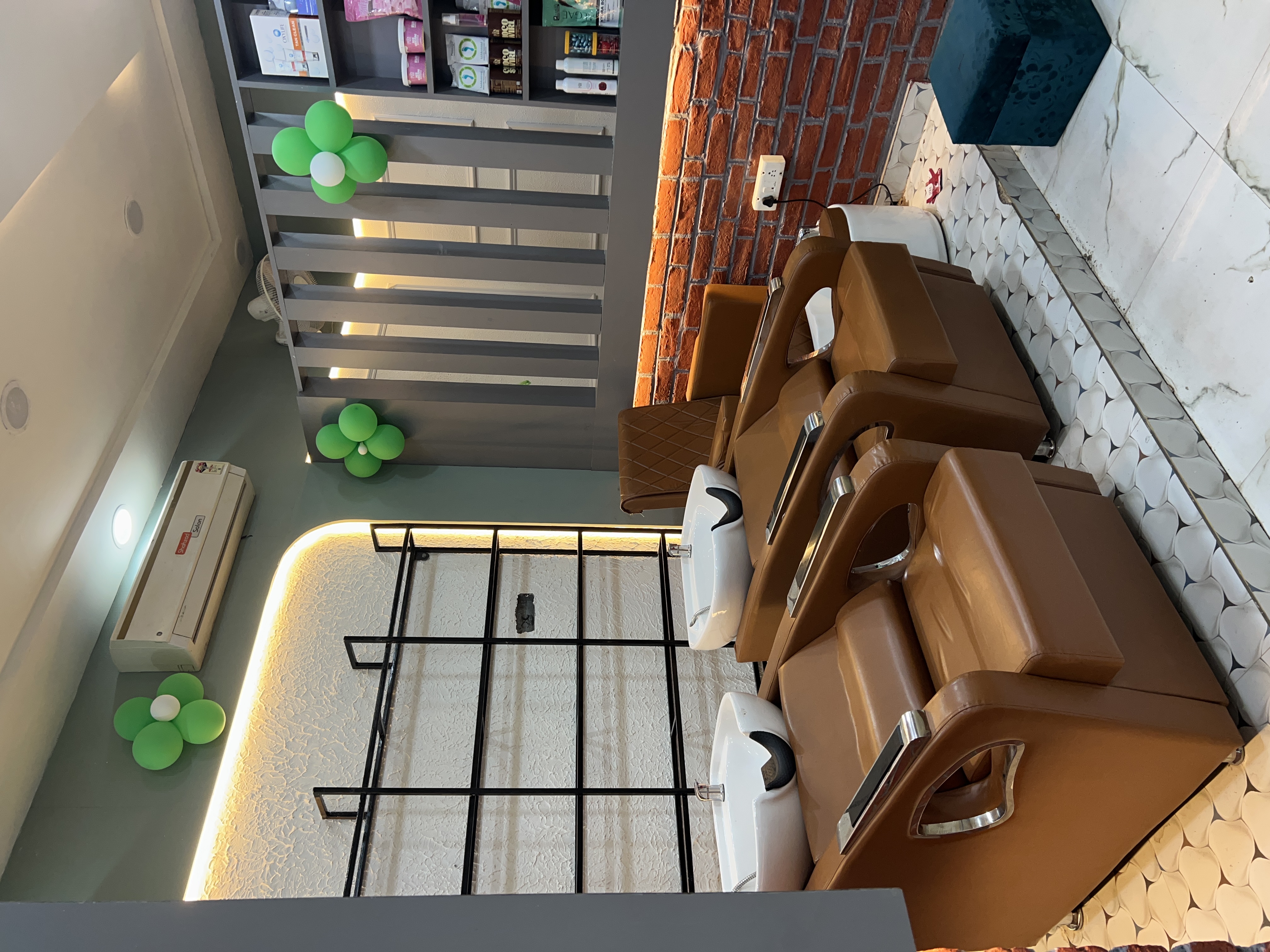 Warm interior of Shahzad Majestic with chandelier and product shelves